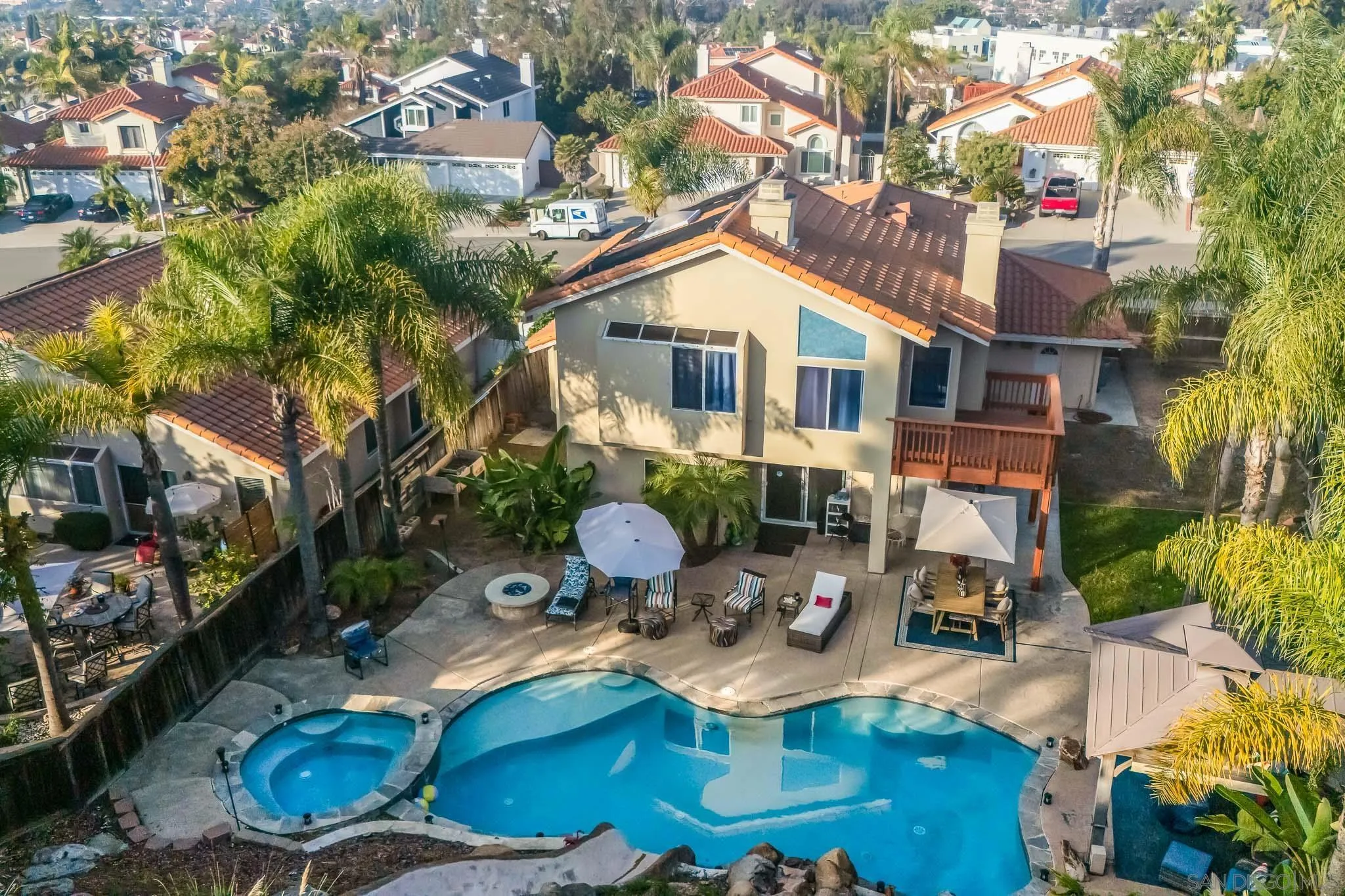 5063 Frazee Road Oceanside, CA 92057 - Photo 43 of 45 a view of a patio with table and chairs potted plants and large tree