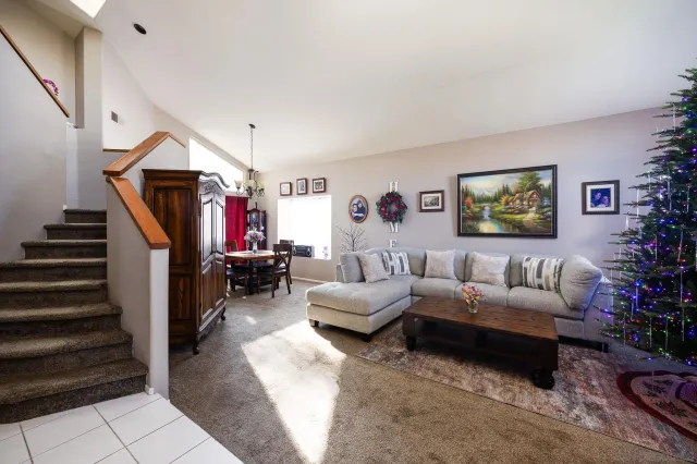 a living room with furniture and a ceiling fan