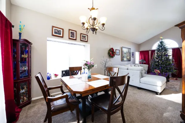 a view of a dining room with furniture and chandelier