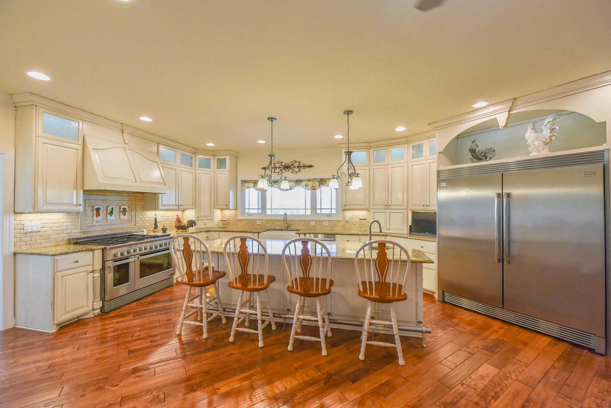 2682 Maple Grove Road Dickson, TN 37055 - Photo 14 of 50 a kitchen with stainless steel appliances granite countertop a table chairs stove and a sink