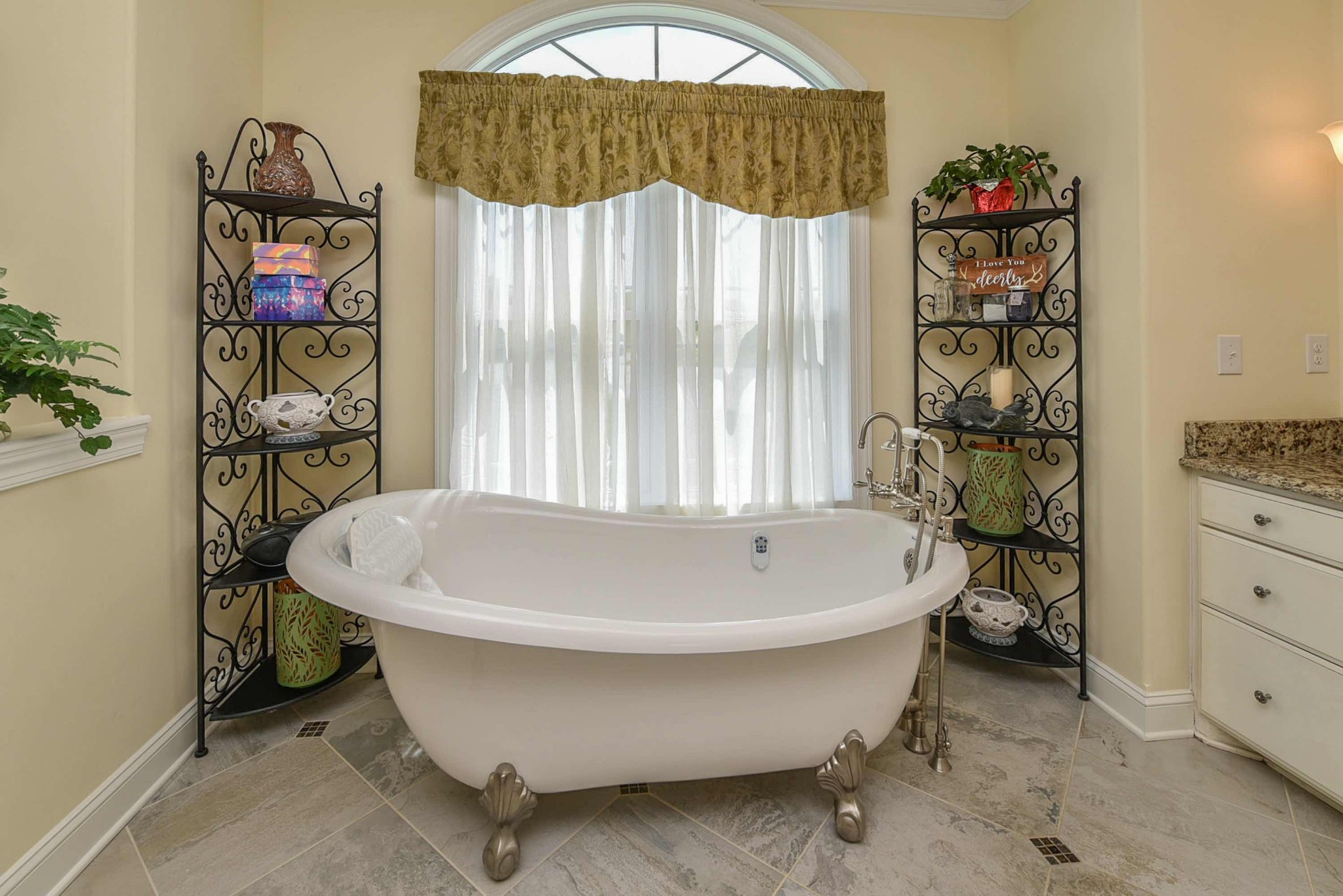 2682 Maple Grove Road Dickson, TN 37055 - Photo 23 of 50 a white bath tub sitting in a bathroom next to a window