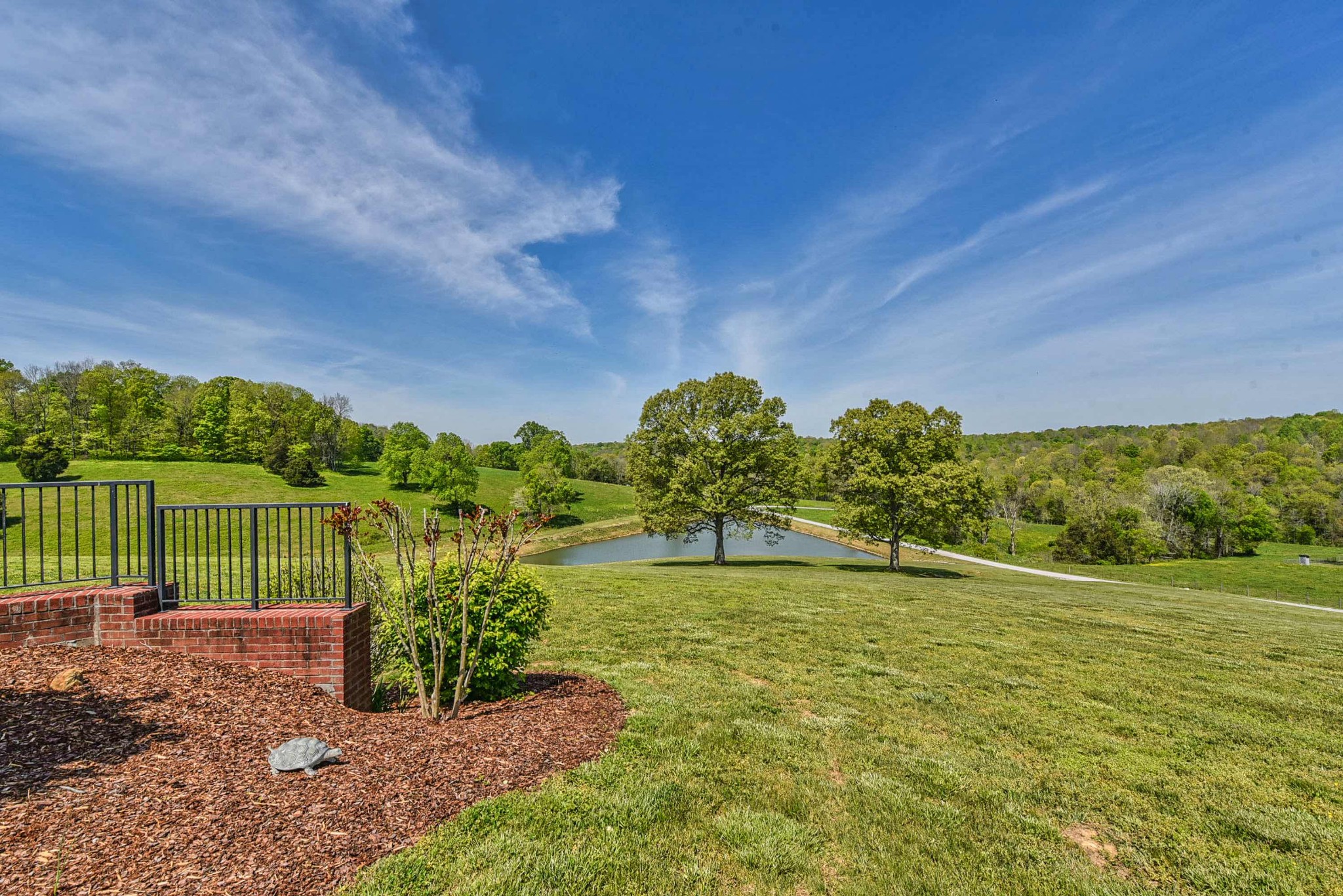 2682 Maple Grove Road Dickson, TN 37055 - Photo 7 of 50 a view of a garden with a building in the background