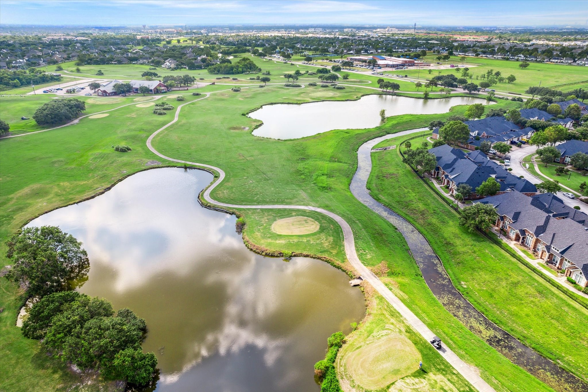 3310 Spring Landing Lane Pearland, TX 77584 - Photo 24 of 32 Aerial view of the golf course and water features that define the area’s scenery.