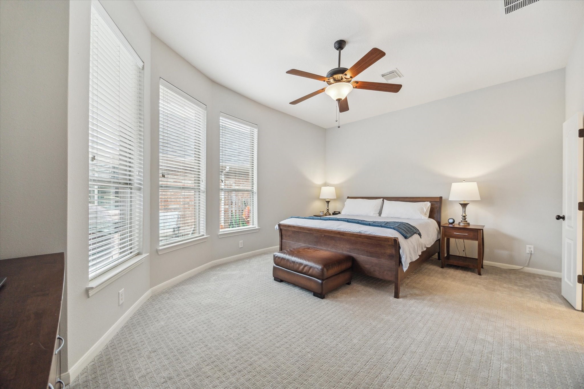 3310 Spring Landing Lane Pearland, TX 77584 - Photo 6 of 32 Large primary suite with soft natural light, ceiling fan, and new carpet