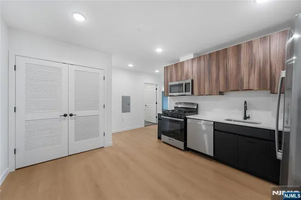 a kitchen with granite countertop stainless steel appliances and wooden cabinets