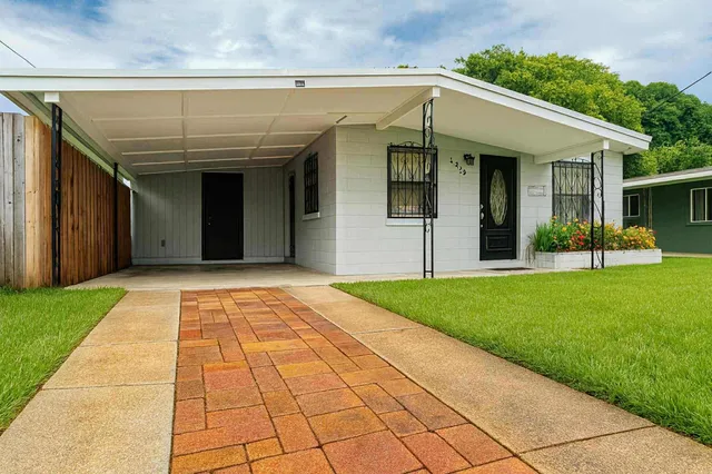 a view of a white house with a large window