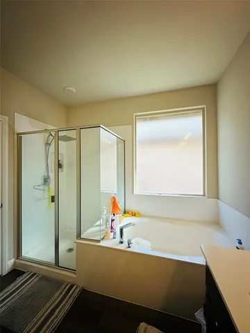 a bathroom with a bathtub and a shower