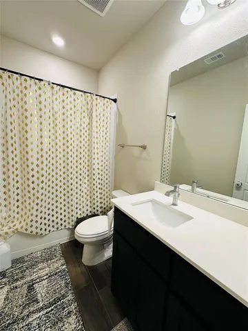 a bathroom with a sink toilet and mirror