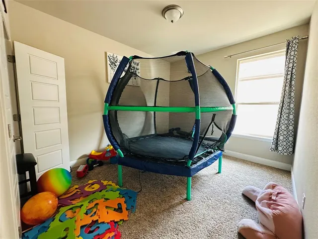 a living room with a couch and a painting on the wall