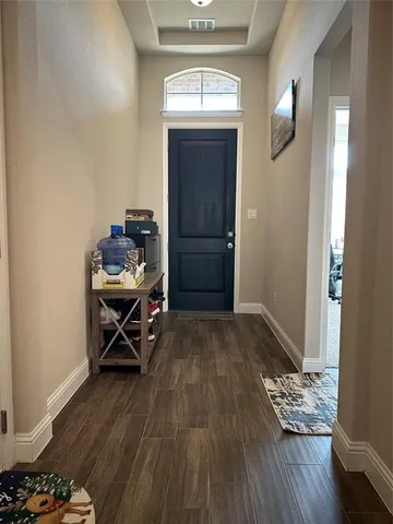 a view of a livingroom with wooden floor and a window