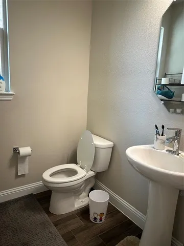 a white toilet sitting next to a bathroom sink