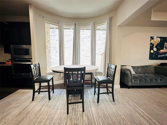 a view of a livingroom with furniture and a window