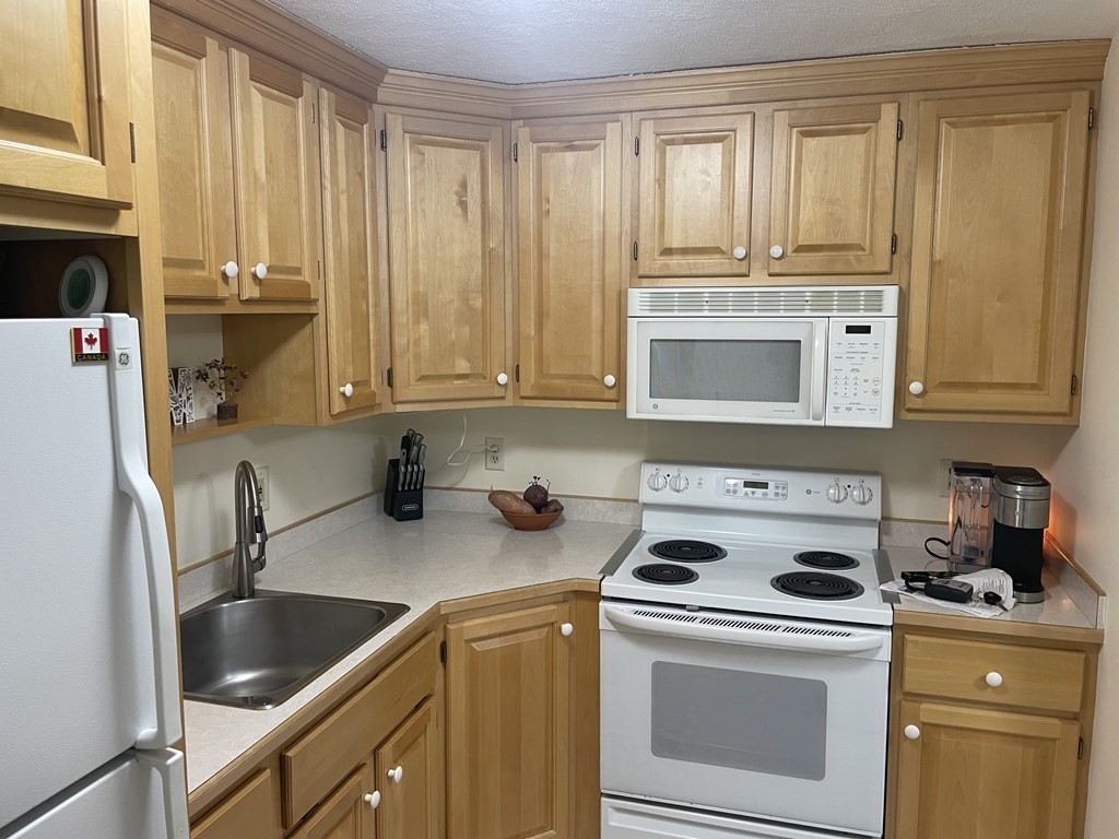 205 Great Road, Unit C8 Acton, MA 01720 - Photo 15 of 34 a kitchen with appliances cabinets and a sink