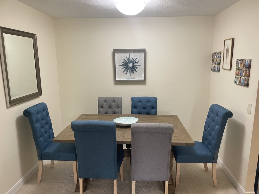 205 Great Road, Unit C8 Acton, MA 01720 - Photo 16 of 34 a view of a dining room with furniture