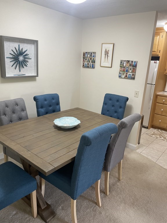 205 Great Road, Unit C8 Acton, MA 01720 - Photo 17 of 34 a view of a dining room with furniture and wooden floor
