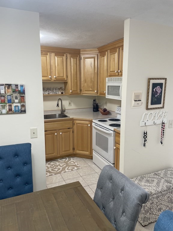 205 Great Road, Unit C8 Acton, MA 01720 - Photo 18 of 34 a kitchen with a stove sink and cabinets