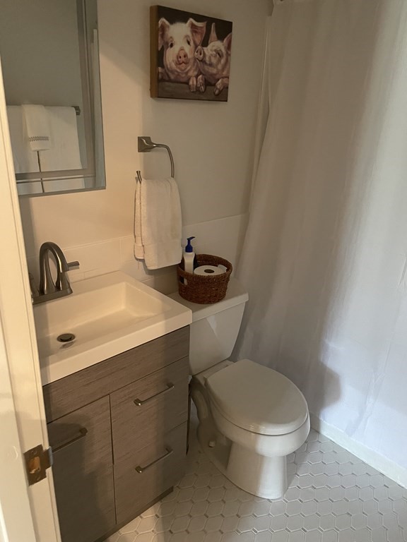 205 Great Road, Unit C8 Acton, MA 01720 - Photo 19 of 34 a white toilet sitting next to a bathroom sink