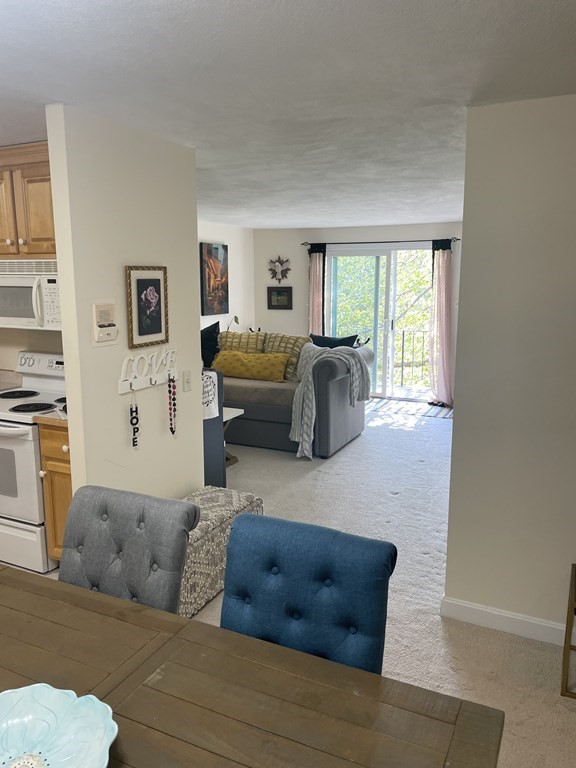 205 Great Road, Unit C8 Acton, MA 01720 - Photo 28 of 34 a living room with furniture and a large window