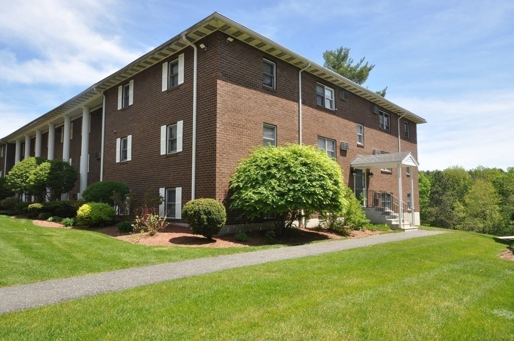 205 Great Road, Unit C8 Acton, MA 01720 - Photo 6 of 34 a front view of a house with a yard
