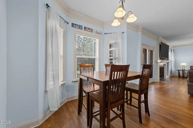 a large kitchen with stainless steel appliances granite countertop a stove a sink dishwasher a microwave oven with cabinets and wooden floor