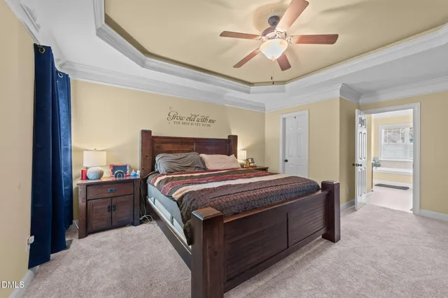 a bedroom with a large bed and a chandelier