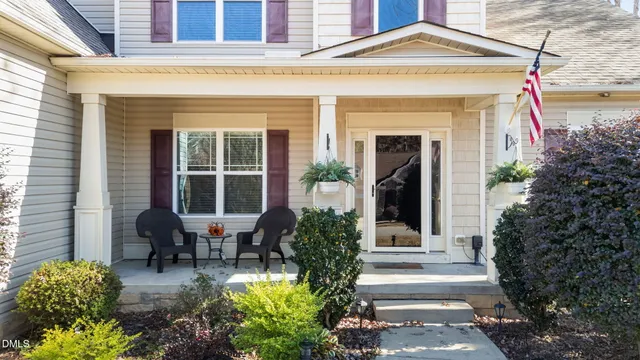a front view of a house with potted plants