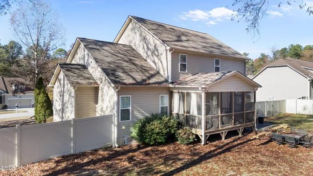 a view of a wooden house with a small yard