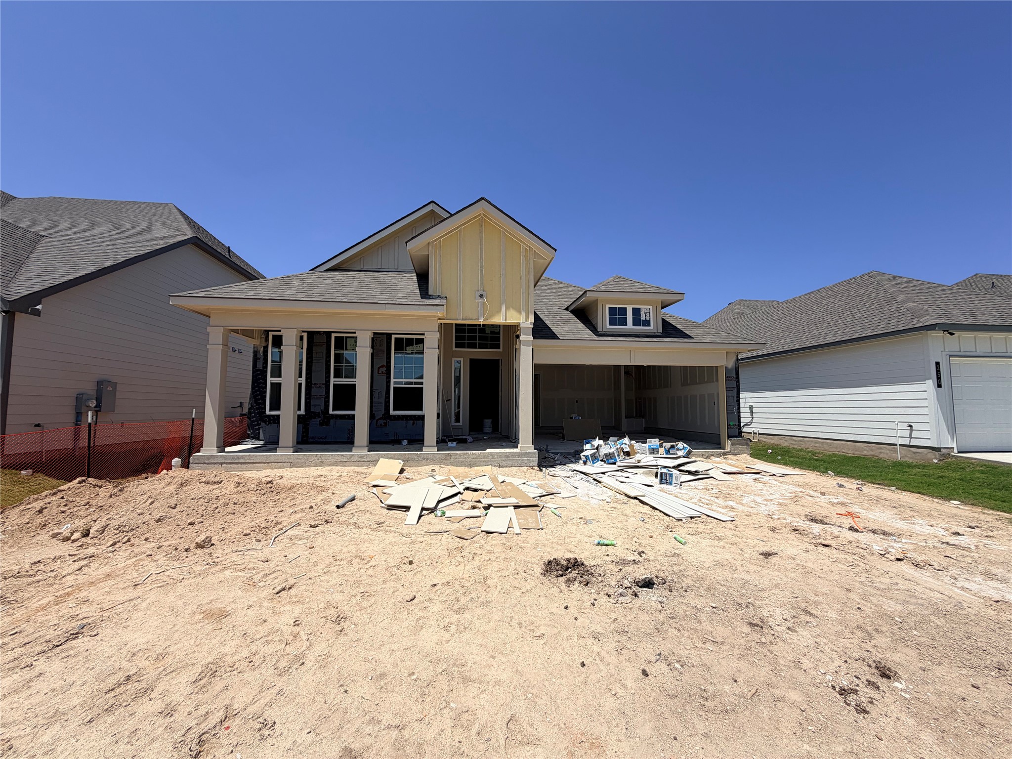 254 Gus Loop Georgetown, TX 78626 - Photo 1 of 16 A newly constructed residence awaits finishing touches, featuring a welcoming covered entry and an attached garage.