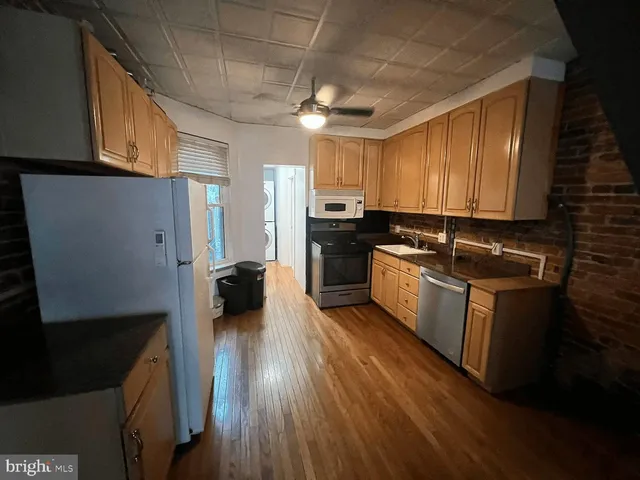 a kitchen with sink a refrigerator and cabinets