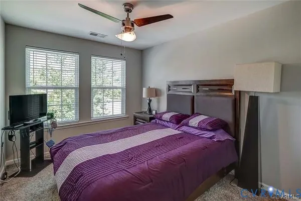 a bathroom with a granite countertop sink toilet and a mirror