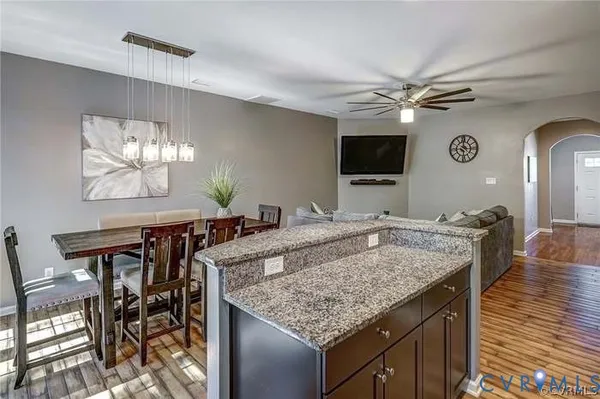 a kitchen with kitchen island granite countertop a refrigerator stove and sink