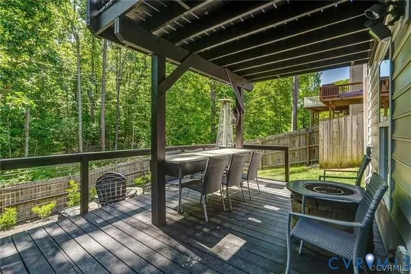 a view of a chairs and table in patio with wooden floor