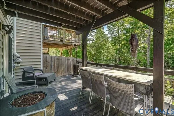 a view of a deck with table and chairs and wooden floor