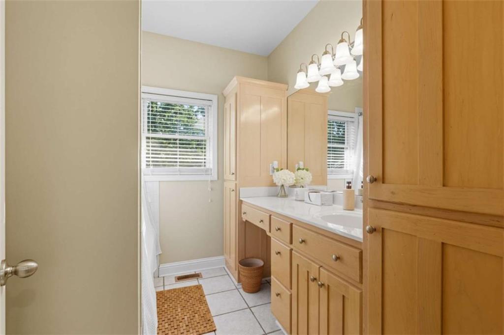 1091 Echota Road Clarkesville, GA 30523 - Photo 28 of 89 a bathroom with a double vanity sink and a mirror