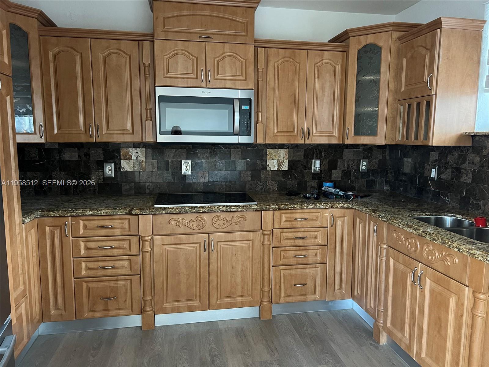 8001 West 36th Avenue, Unit 1 Hialeah, FL 33018 - Photo 11 of 48 a kitchen with stainless steel appliances granite countertop a stove a sink and a microwave