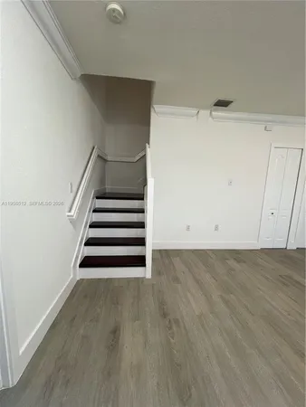 a view of entryway and hall with wooden floor