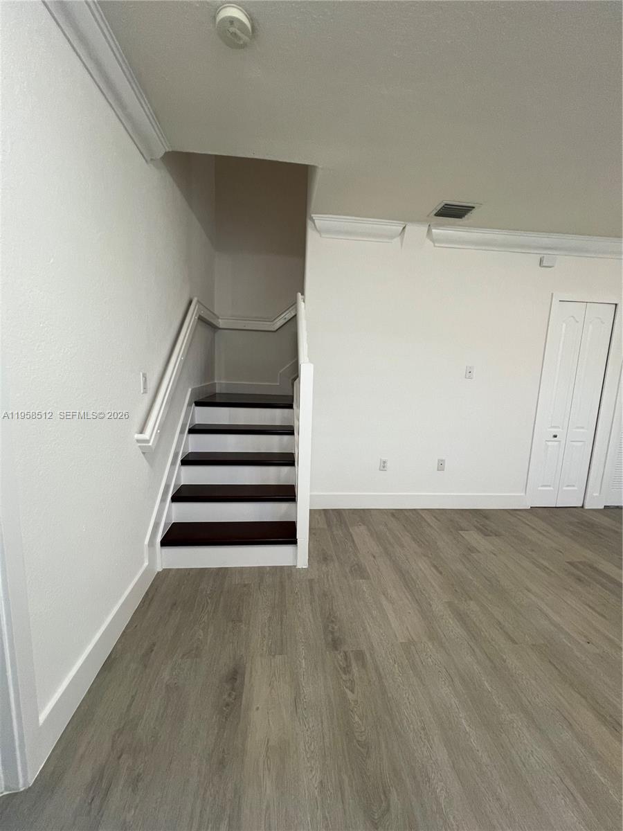 8001 West 36th Avenue, Unit 1 Hialeah, FL 33018 - Photo 18 of 48 a view of entryway and hall with wooden floor