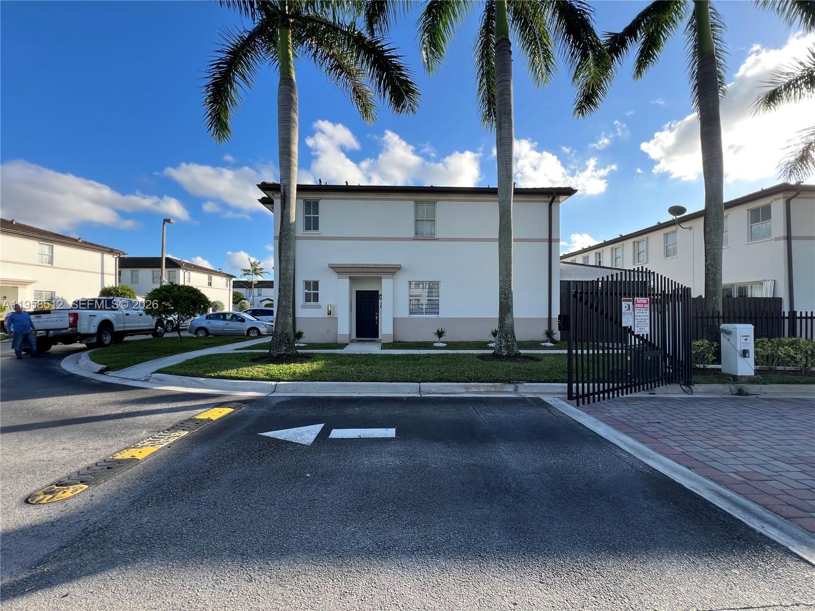 8001 West 36th Avenue, Unit 1 Hialeah, FL 33018 - Photo 2 of 48 a view of a building with a yard
