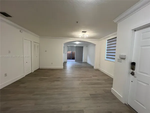 a view of a hallway with wooden floor