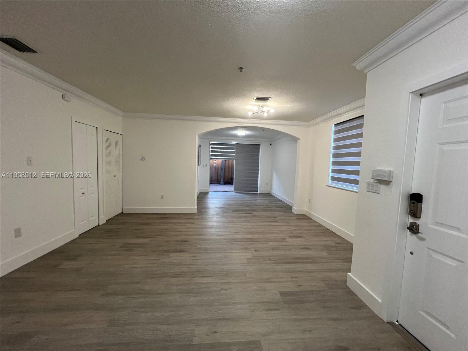 8001 West 36th Avenue, Unit 1 Hialeah, FL 33018 - Photo 21 of 48 a view of a hallway with wooden floor and staircase