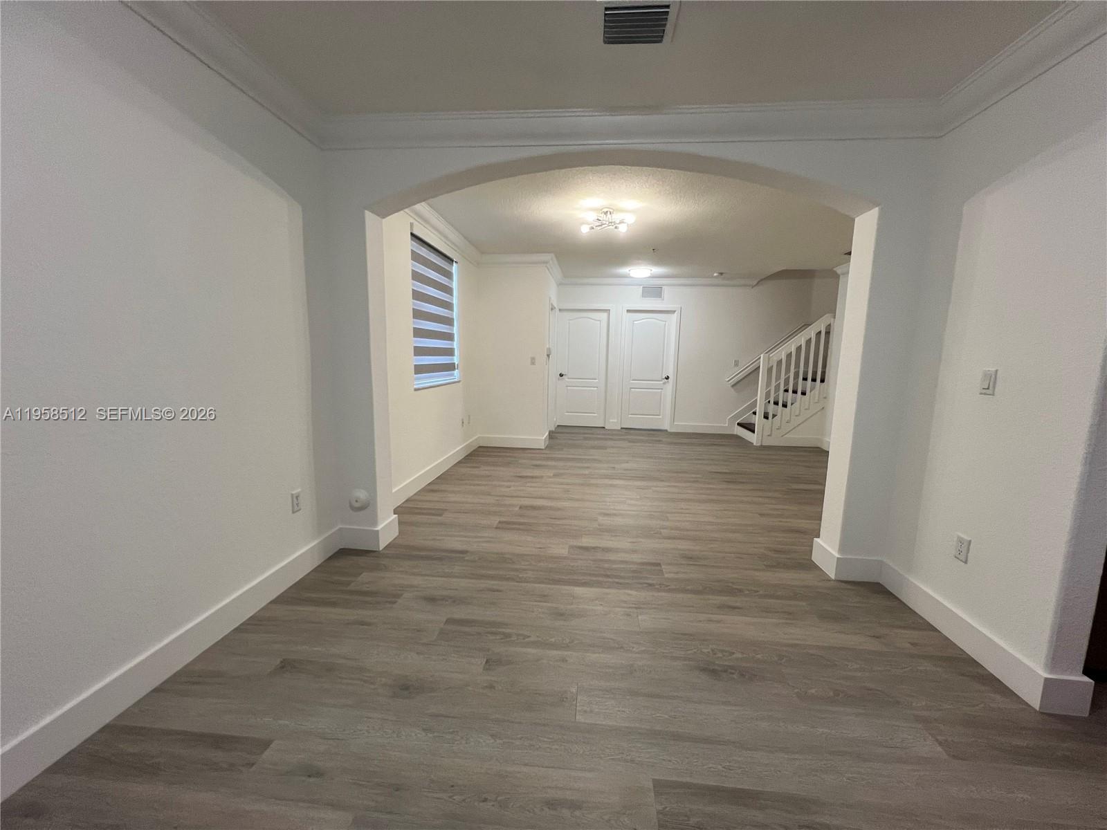 8001 West 36th Avenue, Unit 1 Hialeah, FL 33018 - Photo 22 of 48 a view of a hallway with wooden floor