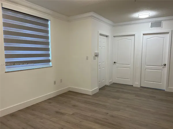 a view of an entryway with wooden floor