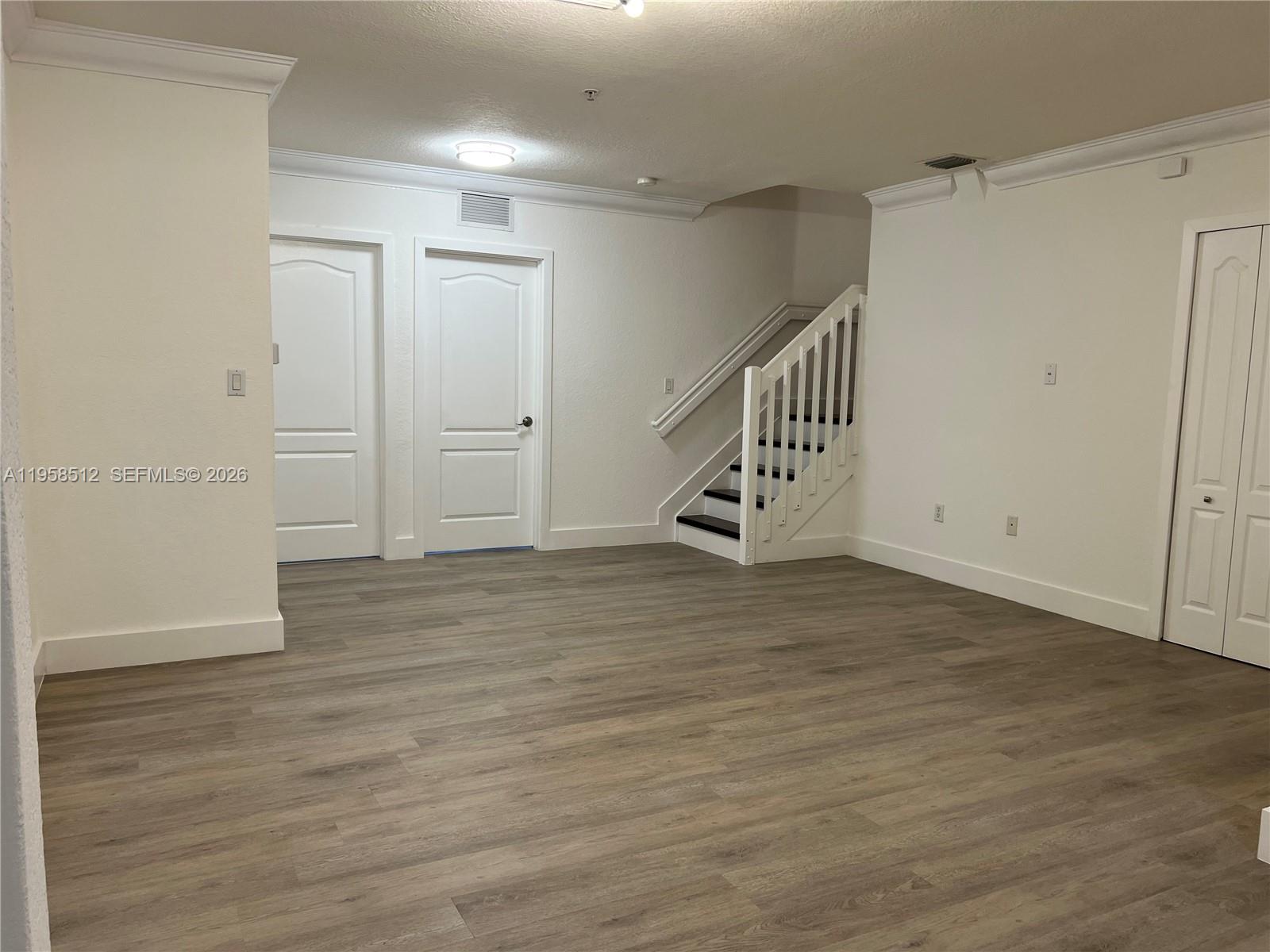 8001 West 36th Avenue, Unit 1 Hialeah, FL 33018 - Photo 26 of 48 a view of an empty room with wooden floor
