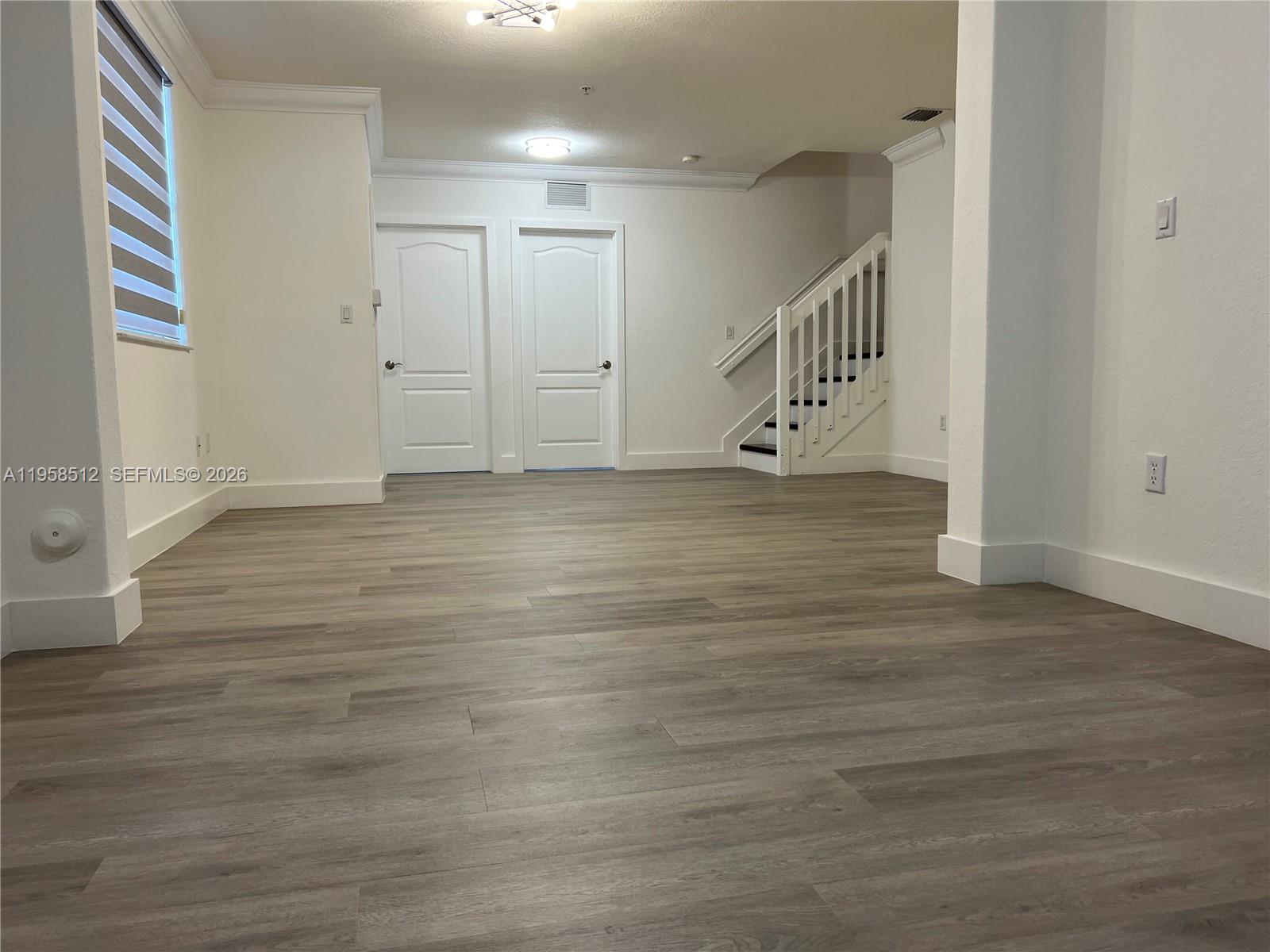 8001 West 36th Avenue, Unit 1 Hialeah, FL 33018 - Photo 28 of 48 a view of an empty room with wooden floor