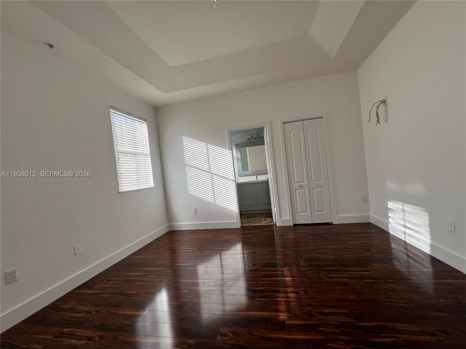 8001 West 36th Avenue, Unit 1 Hialeah, FL 33018 - Photo 36 of 48 a view of empty room with wooden floor and window