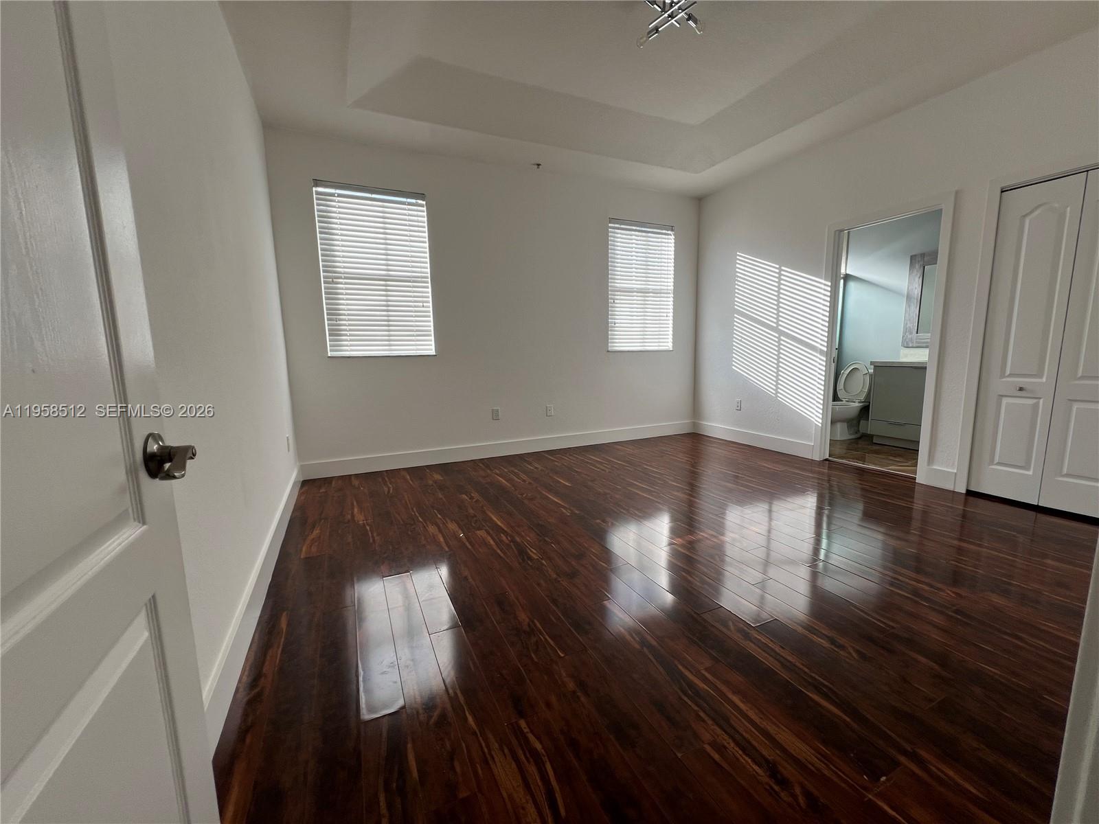 8001 West 36th Avenue, Unit 1 Hialeah, FL 33018 - Photo 37 of 48 wooden floor in an empty room with a window