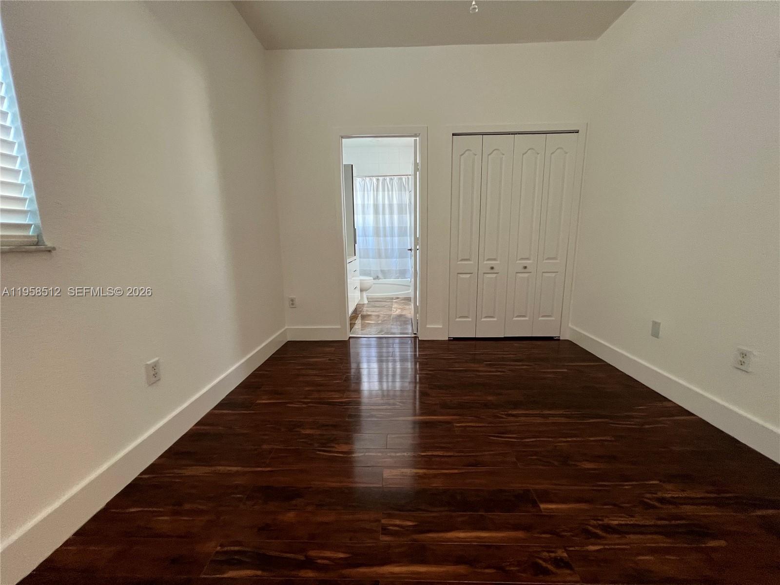 8001 West 36th Avenue, Unit 1 Hialeah, FL 33018 - Photo 40 of 48 a view of empty room with wooden floor