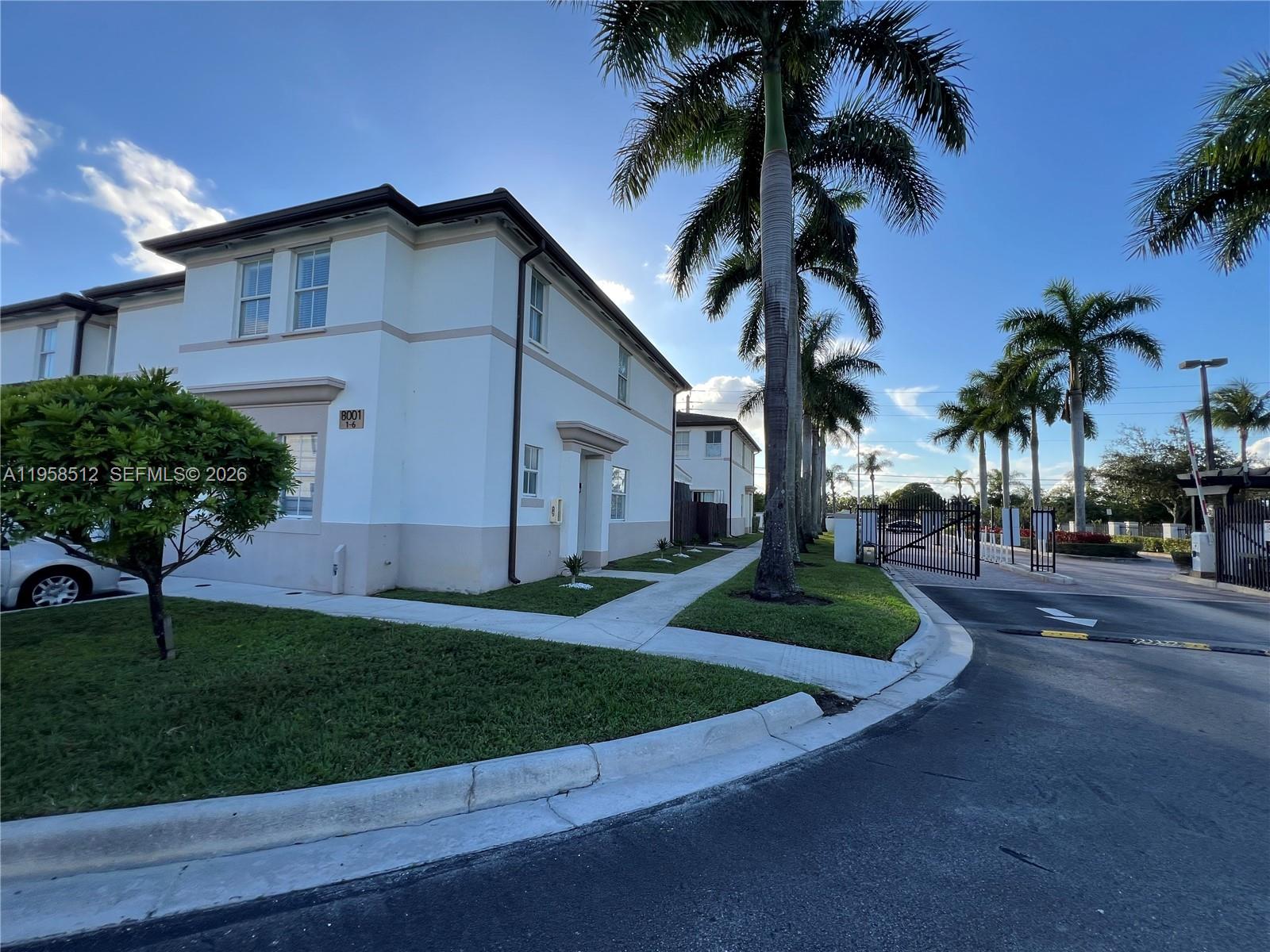 8001 West 36th Avenue, Unit 1 Hialeah, FL 33018 - Photo 4 of 48 a front view of a house with garden and plants