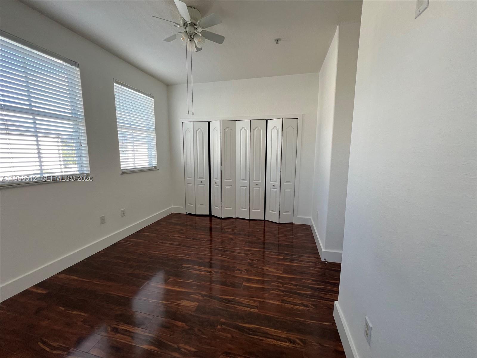 8001 West 36th Avenue, Unit 1 Hialeah, FL 33018 - Photo 48 of 48 a view of an empty room with wooden floor and a window