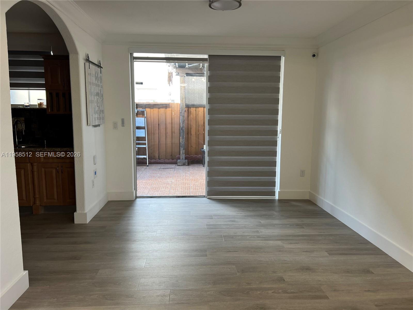 8001 West 36th Avenue, Unit 1 Hialeah, FL 33018 - Photo 7 of 48 an empty room with wooden floor closet and windows